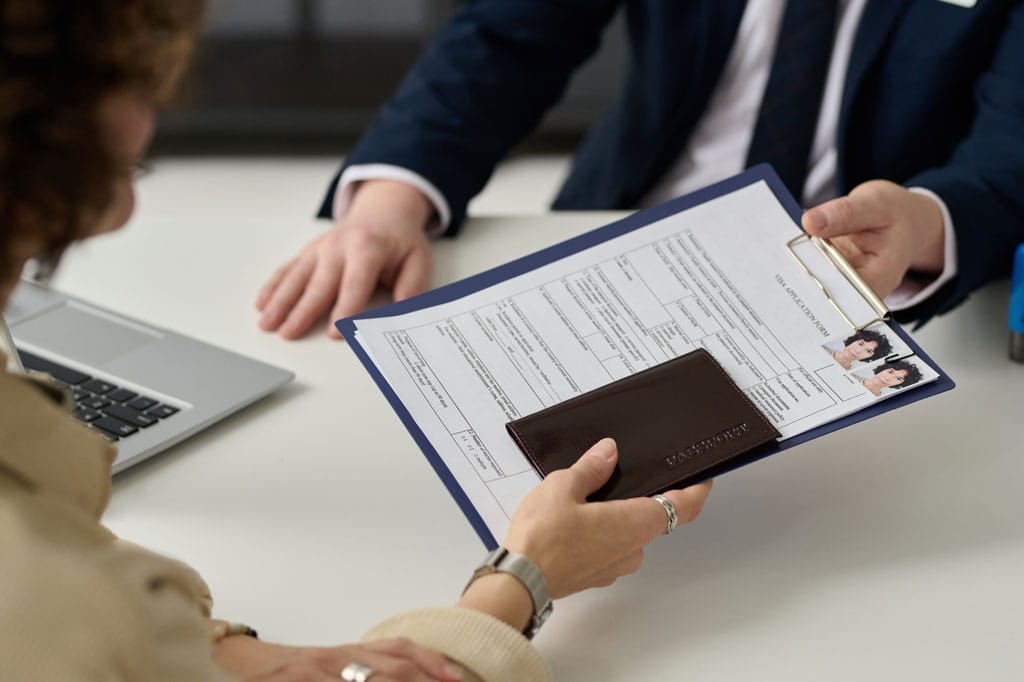 woman holding visa application 2234701511